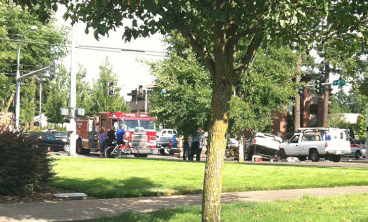 ANTHONY JACOBS 
 Emergency crews respond to a vehicle on its top Monday afternoon.