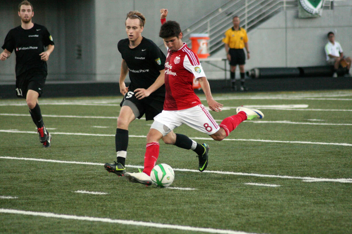 Jose Ribas (right) blisters the soccer ball for the Portland Timbers U-23 team Friday, at Doc Harris Stadium.