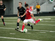 Jose Ribas (right) blisters the soccer ball for the Portland Timbers U-23 team Friday, at Doc Harris Stadium.