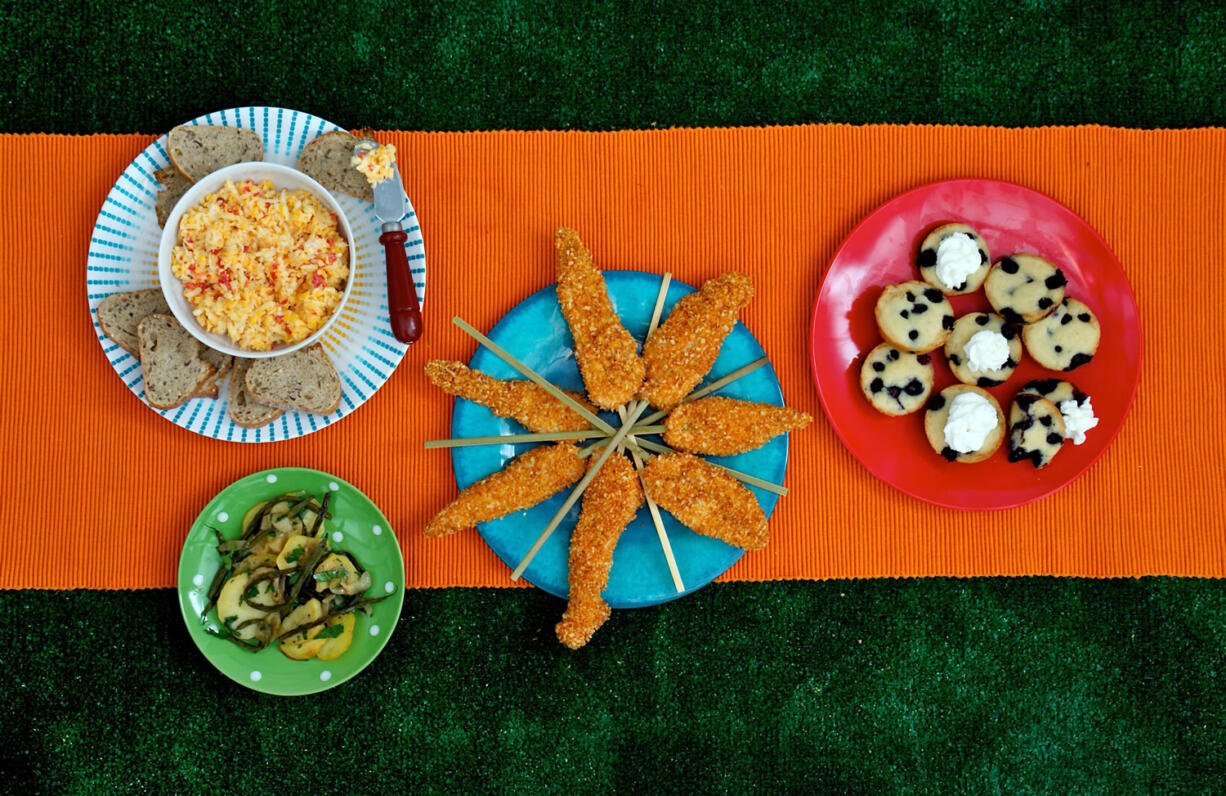 From left, Lightened-Up Pimento Cheese, Roasted Green Bean and Potato Salad, Oven-Fried Chicken on a Stick, and Individual Fruit Cobblers.