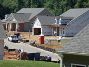 Jason Getz/Atlanta Journal-Constitution
Pulte Group workers build homes in Marietta, Ga., in June. New home construction is on the rise, but higher-cost loans may put the brakes on the trend.