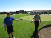 Connor Coombs hands a sand wedge to his father. Green Mountain golf course general manager Kevin Coombs is going to play in the U.S. Senior Open Thursday, July 11, at Ohama (Neb.) Country Club.