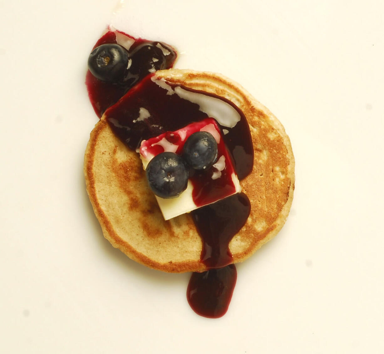 Making pancakes from scratch -- including this Lemon-Ricotta Pancake with Blueberry Sauce -- doesn't take much longer than using a mix and allows you to add differing flavors and textures.