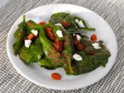 Spinach leaves catch and hold dressing in their folds in this Spinach Salad With Warm Strawberry-Rhubarb Dressing.