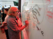 Rosemarie Ives, former mayor of Redmond, contributes an idea to the &quot;idea board&quot; at Northeastern University's offices in Seattle.