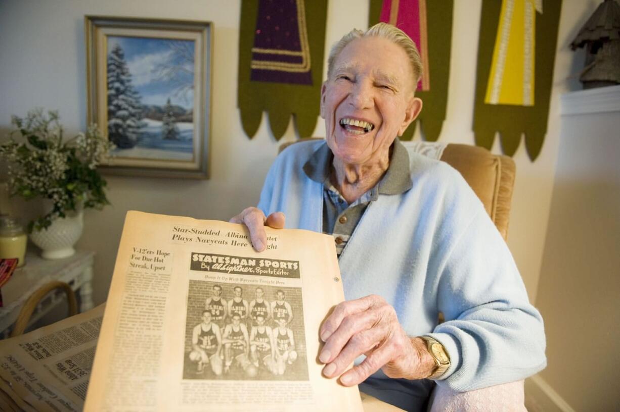 Skeet O'Connell holds up an old newspaper in 2009 that featured a story about a team he was on.