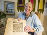 Skeet O'Connell holds up an old newspaper in 2009 that featured a story about a team he was on.