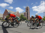 Photos by STEVE DiPAOLA/For The Columbian
Racers in the Category 4 event compete during the Vancouver Courthouse Criterium in downtown Vancouver on Sunday. Nearly 200 riders tested the eight-block, figure-eight course. St. James Catholic Church is in the background.