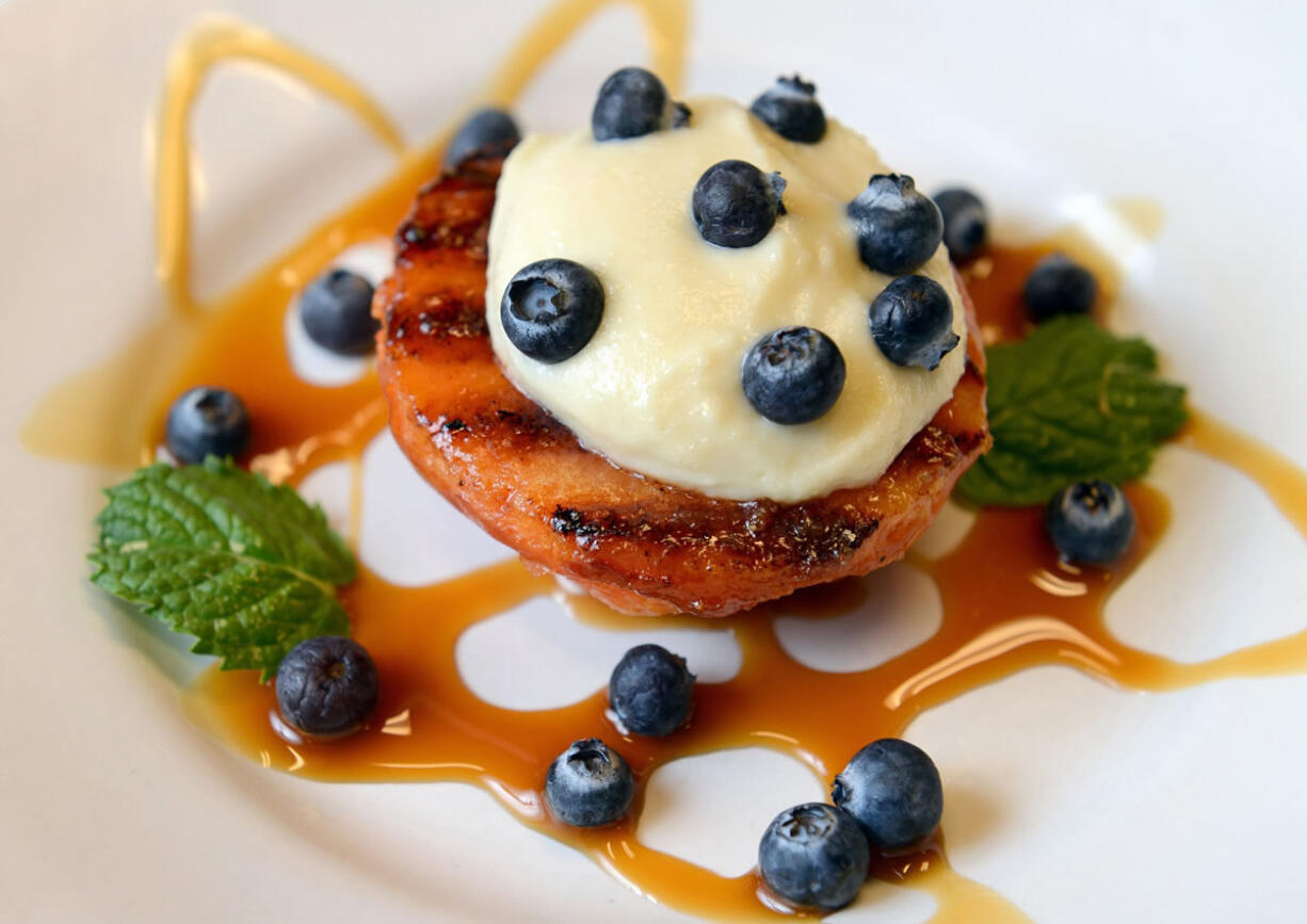 Grilled peaches with almond paste filling was prepared by chef Adrianna Oropeza at Sierra Nut House in Fresno, Calif.