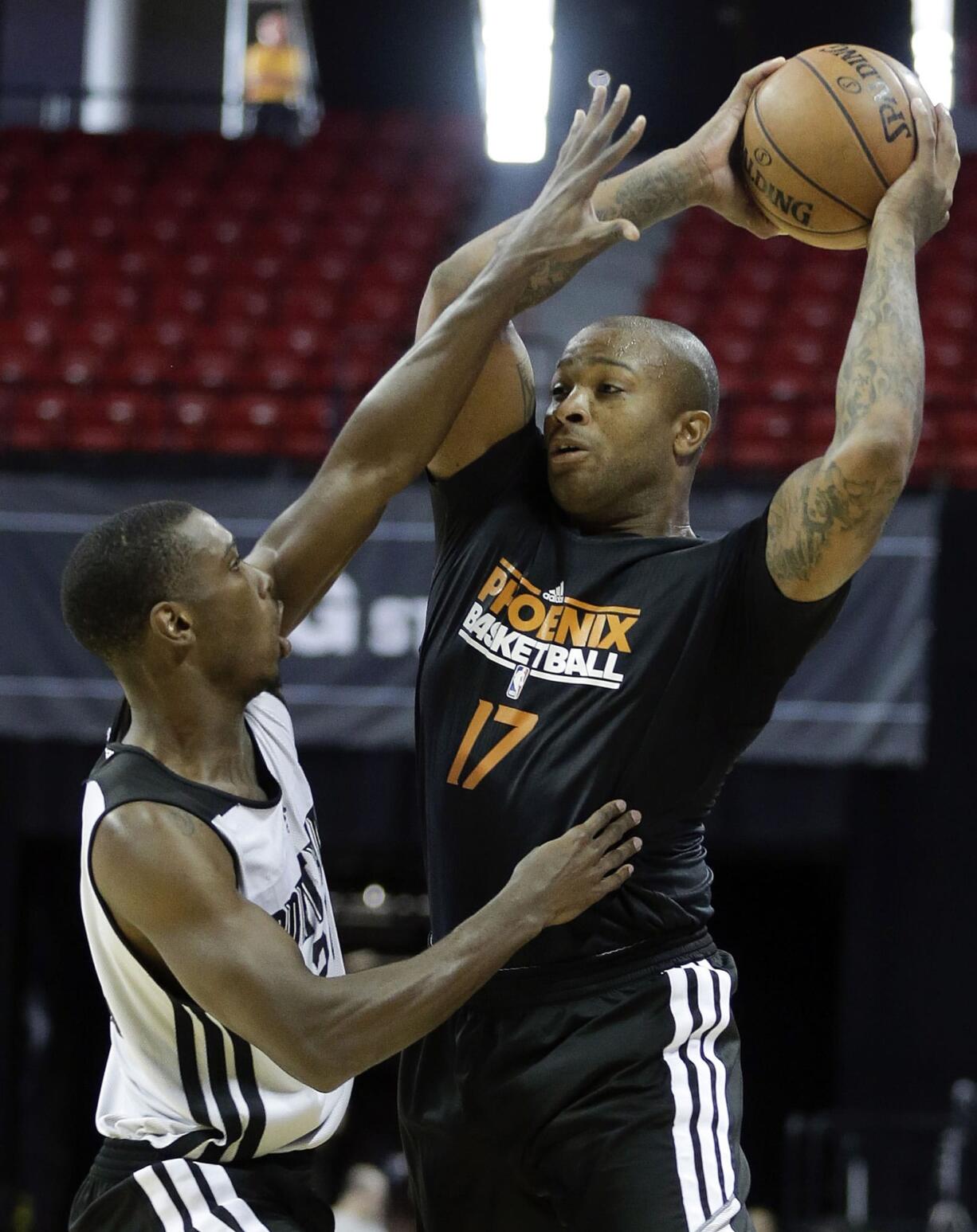 Portland's Terrel Harris, left, defends against Phoenix's P.J. Tucker in a Summer League game.