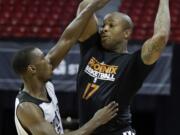 Portland's Terrel Harris, left, defends against Phoenix's P.J. Tucker in a Summer League game.