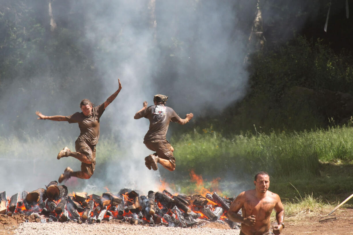 Getting muddy and jumping over fire are just some of the crazy obstacles designed to push humans to the limit during the Washington State Spartan Sprints Saturday and Sunday, at Washougal Motocross Park.