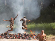 Getting muddy and jumping over fire are just some of the crazy obstacles designed to push humans to the limit during the Washington State Spartan Sprints Saturday and Sunday, at Washougal Motocross Park.