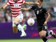 United States' Alex Morgan, left, vies for the ball with New Zealand's Abby Erceg, right, during their women's quarter-final soccer match at St James' Park in Newcastle, England, during the London 2012 Summer Olympics, Friday, Aug.