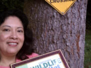 La Center:  Anita Maret shows off the certificate that says her property is going wild.