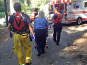 Firefighters tend to a 32-year-old man who was injured Sunday afternoon at Daybreak Park near Battle Ground.