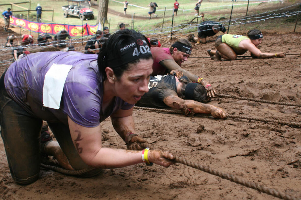 Spartans climb up Horsepower Hill using only a rope, brute strength and teamwork Saturday, at Washougal Motocross Park.