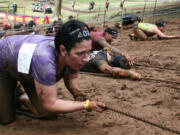 Spartans climb up Horsepower Hill using only a rope, brute strength and teamwork Saturday, at Washougal Motocross Park.