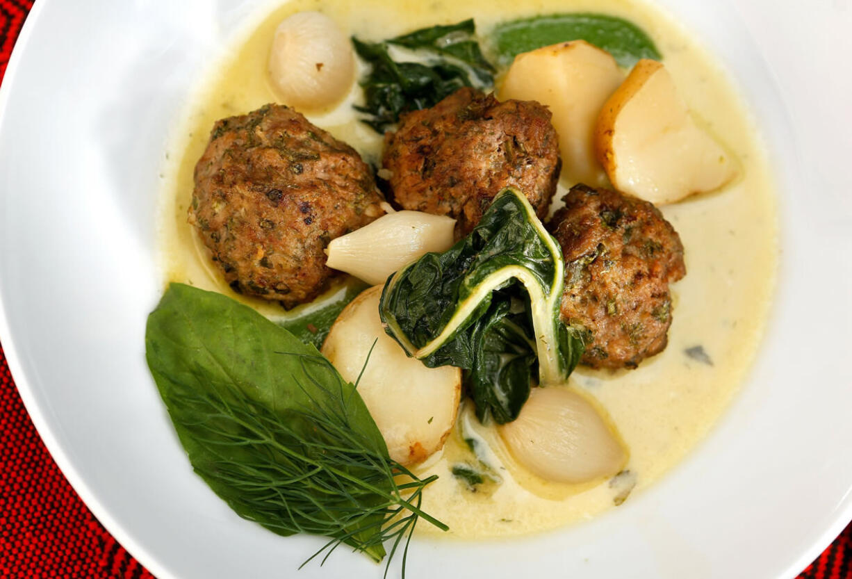 Meatball Haslama with Tahini Liaison should be served immediately in warmed bowls, garnished with a sprinkling of sea salt, fresh basil, dill and a drizzle of olive oil.