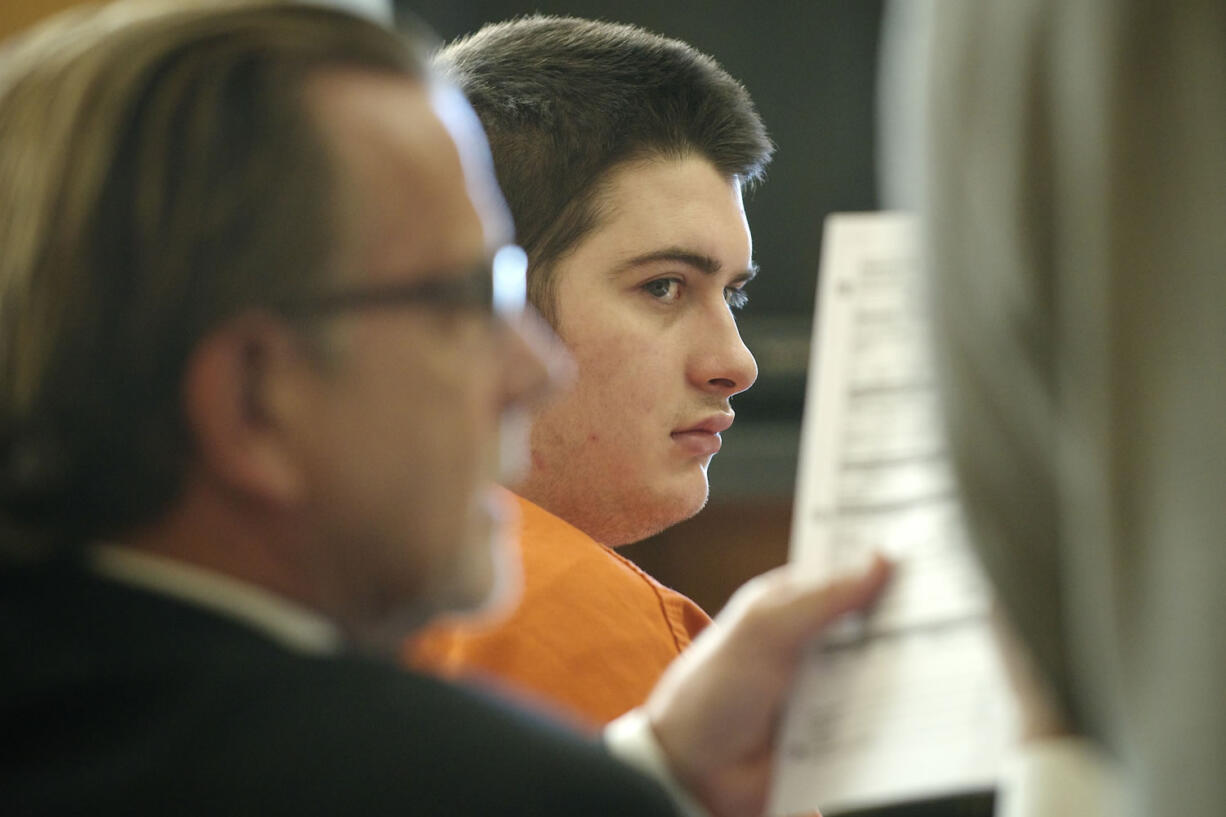 Matthew Starr, right, waits as his attorney, John Henry Browne, reviews documents at a motion-to-dismiss hearing July 15 in Clark County Superior Court Judge Rich Melnick's courtroom.