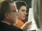 Matthew Starr, right, waits as his attorney, John Henry Browne, reviews documents at a motion-to-dismiss hearing July 15 in Clark County Superior Court Judge Rich Melnick's courtroom.