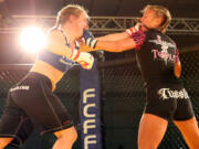 Emily Whitmore (right) throws fists with Liz Tracy during Caged at the Coast 6, in Lincoln City, Ore. Whitmore, who grew up in Washougal, will fight for the FCFF Female 125-pound championship at Rumble at the Roseland 65, Aug.