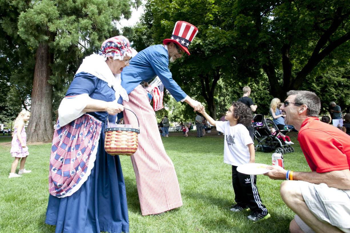 Isaiah Allen, 4, shakes hands with &quot;Uncle Sam&quot; at Sunday's veterans court benefit.