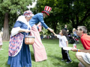 Isaiah Allen, 4, shakes hands with &quot;Uncle Sam&quot; at Sunday's veterans court benefit.