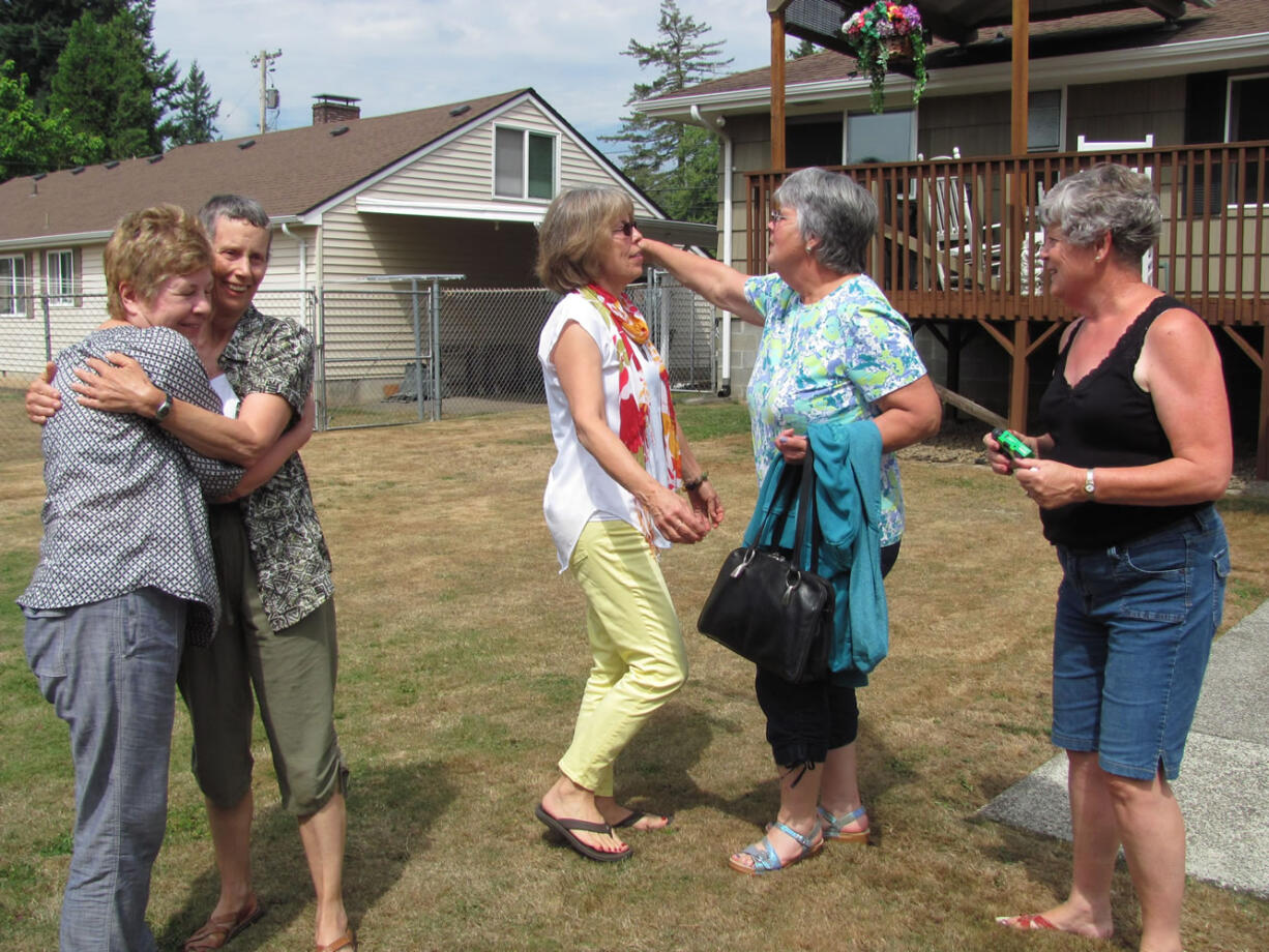 The former classmates greeted each other with hugs and laughter.