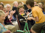 Florence Wager, center, was honored as Clark County's First Citizen for 2009 during a reception that included four cyclists who rode through as a nod to her role in establishing hiking trails and bike paths.