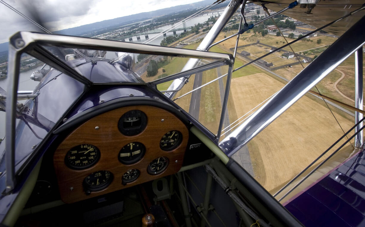 Curt Jacobson, of Ridgefield, (not pictured) flies his father-in-law's 1941 Boeing-Stearman biplane over Pearson Field in 2010.