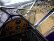 Curt Jacobson, of Ridgefield, (not pictured) flies his father-in-law's 1941 Boeing-Stearman biplane over Pearson Field in 2010.