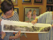 Artist Maria Repetto and downtown Camas art gallery owners Sharon Ballard and Marquita Call (left to right) hold the photograph that is the inspiration for the first mural that will be part of the Camas-Washougal Mural Project. The image of downtown Camas was taken in 1911 or 1912 from Northwest Sixth Avenue and Division Street, according to the picture's owner Brent Erickson. The mural will be painted by Repetto and mounted on a 3 foot by 30 foot space above the entry to the Ballard &amp; Call Fine Art Gallery.