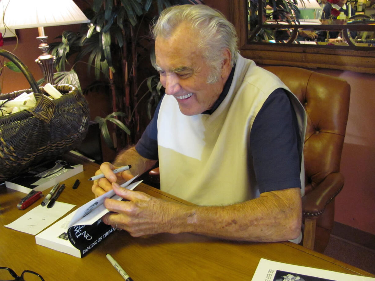 Jimmie Rodgers signs copies of his book, &quot;Dancing with the Moon,&quot; during an event last year in Camas. He will return to his hometown on Friday, Sept. 13, for a ceremony being held to officially announce a street being renamed in his honor. On Saturday, Sept.