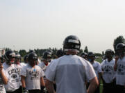 Drew Clarkson leads the Papermakers in a rally cry at the start of football practice Thursday.