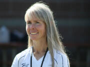 New Camas High School cross country coach Laurie Porter gets excited as she watches the Papermakers practice Monday.