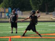 Quarterback Chase Duey delivers a pass from the orange Washougal &quot;W.&quot; The Panthers play their first football game on the new turf at Fishback Stadium Friday, Sept. 6.