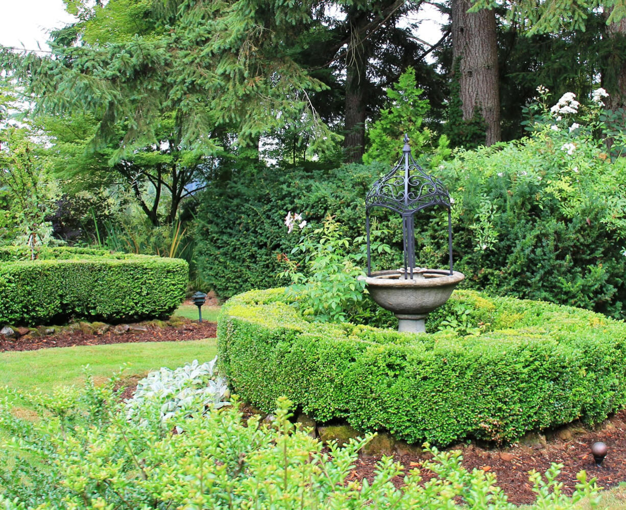 Robb Rosser
A small, classic formal garden area highlights the eclectic style of this country garden.