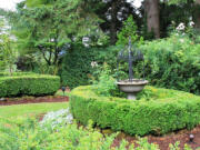 Robb Rosser
A small, classic formal garden area highlights the eclectic style of this country garden.