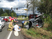 Emergency personnel work the scene of a t-bone crash at Northeast 152nd Avenue and 119th Street in Brush Prairie.