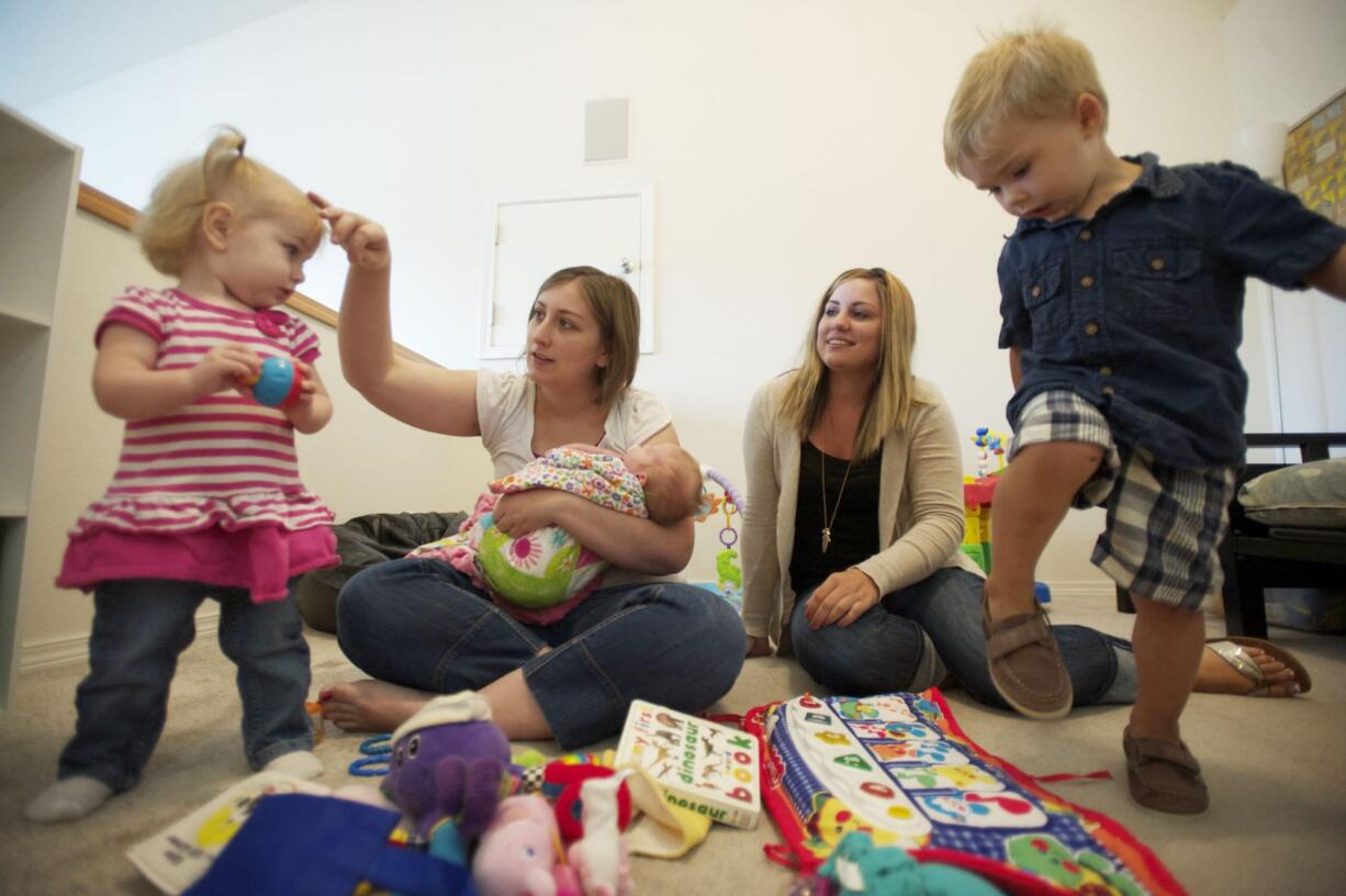 Stephanie Wright, left, with her daughters Sidney, 19 months, and Skylar, 3 weeks, and Erica Cyr, with her son, Tristan, 2, have started a website to sell used kids items.