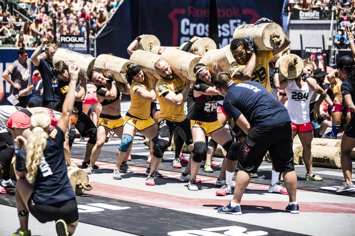 CrossFit Fort Vancouver team members work with the worm -- six 75-pound log pieces connected by rope --during the world championships in Carson, Calif., in July.