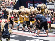 CrossFit Fort Vancouver team members work with the worm -- six 75-pound log pieces connected by rope --during the world championships in Carson, Calif., in July.