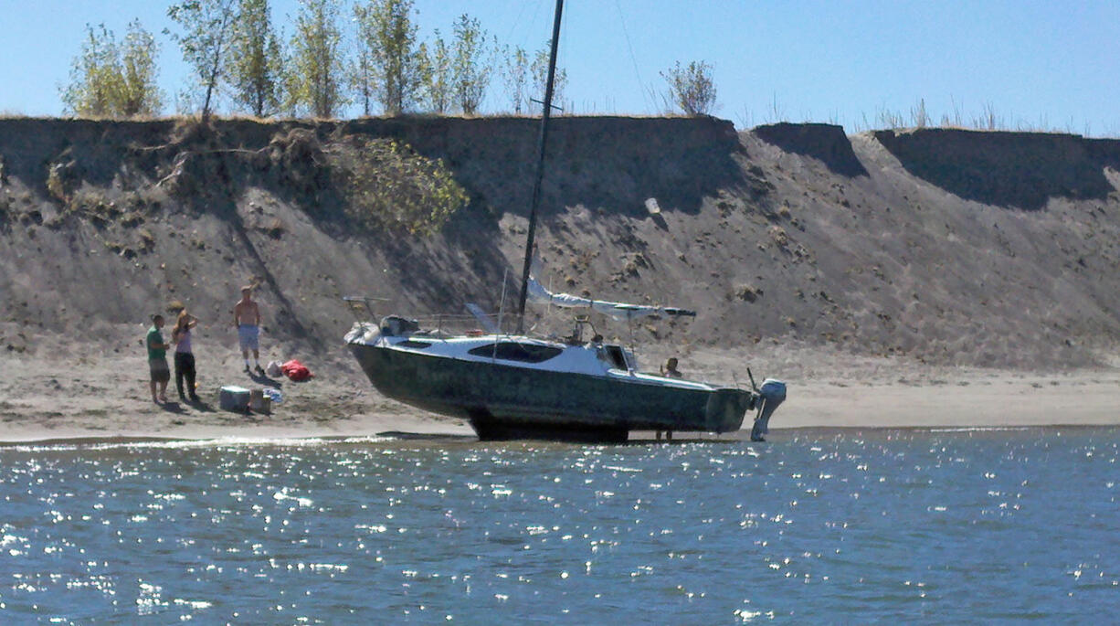 This boater sits aground at Lemon Island in the Columbia River on Sunday.