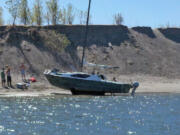 This boater sits aground at Lemon Island in the Columbia River on Sunday.