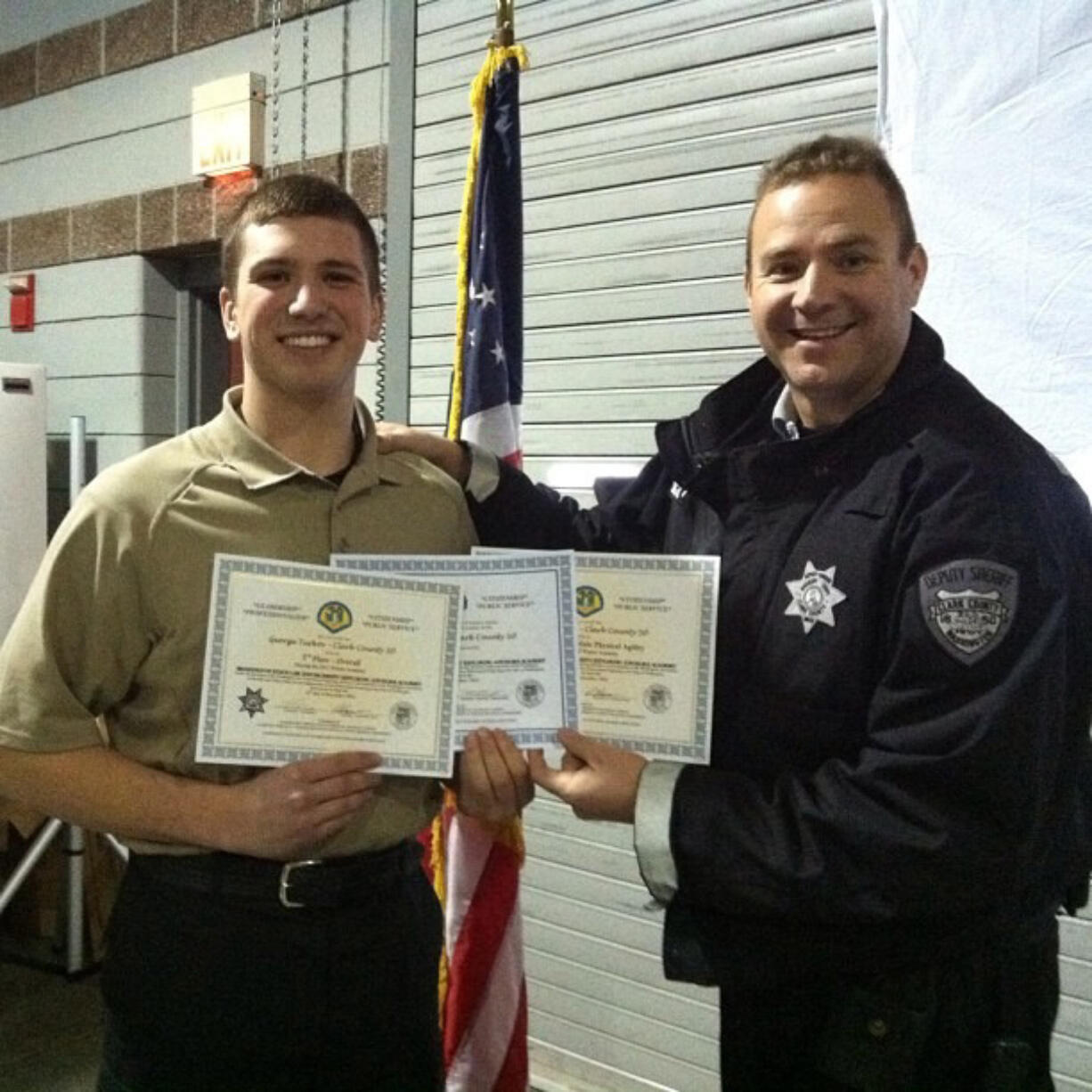 Clark County Sheriff's Office Sgt. Shane Gardner, right, honors George Turkov on his Dec. 31 graduation from the Washington Law Enforcement Explorer Advisors Academy.