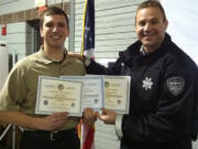 Clark County Sheriff's Office Sgt. Shane Gardner, right, honors George Turkov on his Dec. 31 graduation from the Washington Law Enforcement Explorer Advisors Academy.