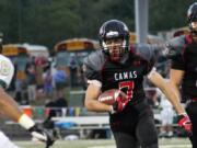 Camas High School senior Nate Beasley (7) gallops to the first of five touchdowns Friday, at Doc Harris Stadium.