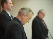 Clark County Commissioners David Madore, from front, Steve Stuart and Tom Mielke pause for prayer before the start of a commissioners meeting at the Clark County Public Services Center earlier this year.