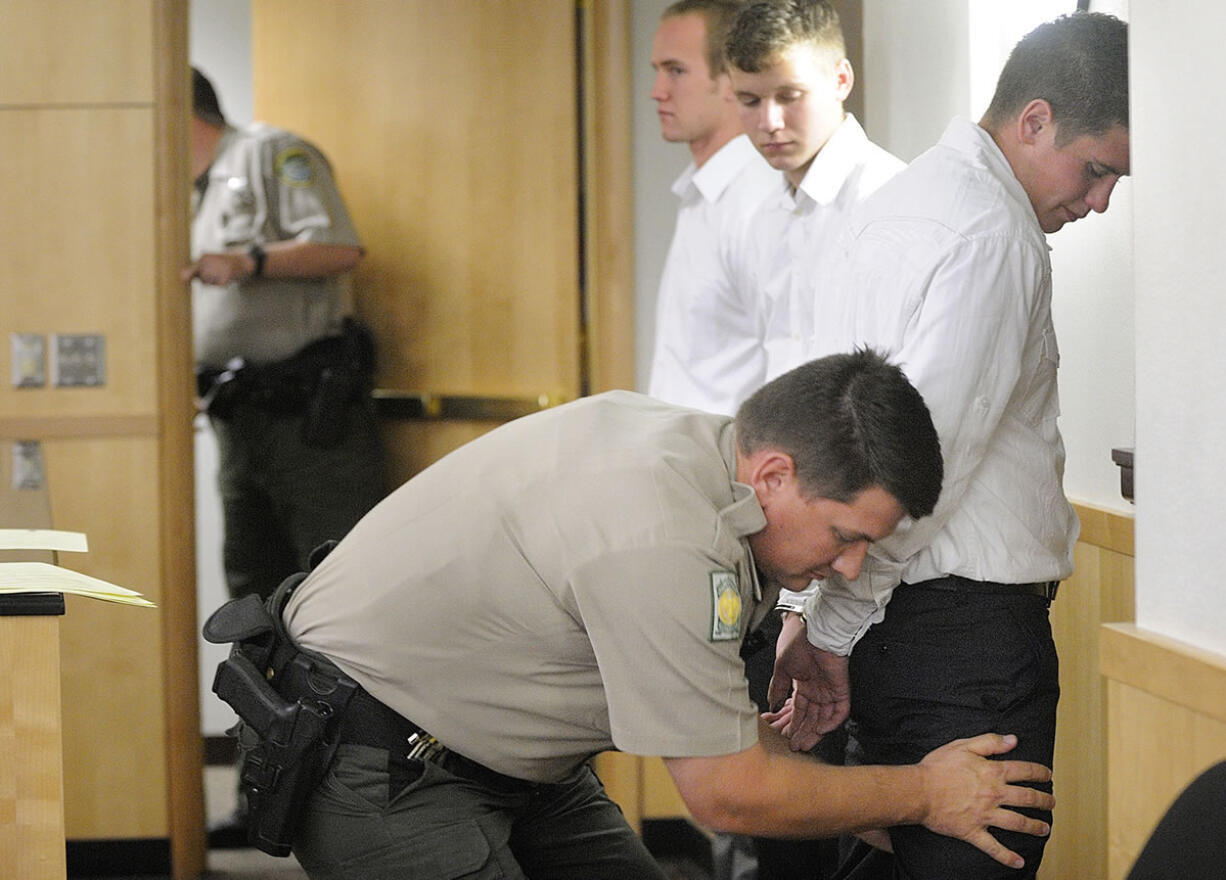 Mitchell Kangas, right, Jaren Koistinen, center, and Riley Munger, were sentenced on Oct. 4, 2011, for shooting cats in the Battle Ground area.